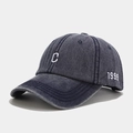 Close-up of vintage washed denim baseball cap with white C embroidery and 1999 side detail - Adjustable / Navy Blue