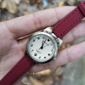 Close-up of bronze cat-ear watch with red leather strap and heart dial in a nature setting - Red (63690)