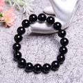 Polished 7A natural black agate beaded bracelet displayed on a white ceramic hand mold - 12MM Natural Black Agate