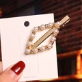 Detailed view of a gold geometric pearl hair clip with diamond accents on a brand card - Alloy Diamond-shaped Pearl Duckbill Clip / Individually Packed in OPP Bag
