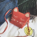 Cute orange cat-shaped mini crossbody bag with embroidery for kids in a flat lay view - Orange