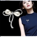 Silver bow brooch featuring drop pearls and sparkling crystals on elegant black background - No. 12-Silver Bow Double Pearl