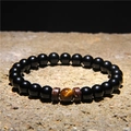 Men's volcanic stone bracelet with a brown tiger eye bead on a textured slate - Obsidian Beads + Tiger Eye + Metal Spacers (FD0176)