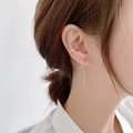 Gold cuff earring with cubic zirconia cross and long tassel chain worn on ear - C Cross Style