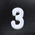 Translucent number 3 shaped silicone mold for DIY resin crafts on black leather - Number-3