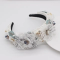 Macro shot of white lace floral headband with blue beads and faux pearl embellishments - White