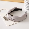 Light gray knotted headband with smooth satin texture on minimalist display card - Gray
