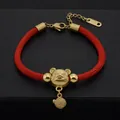 Detailed view of red woven couple bracelet with a golden zodiac mouse charm and beads - Rich Mouse Style