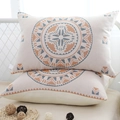 Gauze cotton pillowcases with orange and blue geometric patterns in a cozy bedroom - Sun God (Pair)