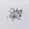 Macro shot of 0.5x3.5mm black stainless steel open jump rings for jewelry making - Black