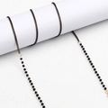 Catenina per occhiali placcata oro con perle nere sfaccettate e maglie in metallo fine - Catena con Perline Nero Oro