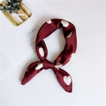 Elegant wine red silk scarf with white heart patterns in a knotted fold presentation - Large Heart Red Base / One Size