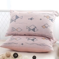 Pair of pink cotton gauze pillowcases featuring geometric fish patterns and soft texture - Pink Fish (Pair)