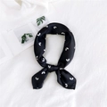 Elegant black satin square scarf with white heart patterns tied in a stylish bow - Heart Pattern Black / One Size