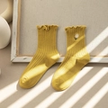 Bright yellow ribbed crew socks with lace trim and daisy embroidery in soft sunlight - One Size / Yellow