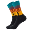 Mid-calf socks featuring desert sunset pattern with black cactus silhouettes and blue cuffs - Sunset Orange