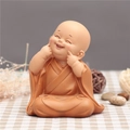 Cute terracotta colored monk figurine in a laughing pose for desktop decoration - 1034-3 Cheeks Poking Cute