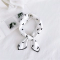 White satin silk scarf with black heart pattern tied in a chic necktie knot style - Heart Pattern White / One Size