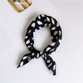 Elegant black and white printed silk scarf tied in a knot on minimalist white background - Petal Pattern Black Base / One Size