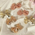 Close-up of metallic bow hair clips in gold and bronze on a white fabric background - 6-Piece Set - Metallic Color Combo