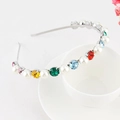 Detail of a thin silver headband with colorful rhinestones and pearls on a coffee cup - Style 13 Silver