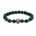 Detailed shot of malachite green beaded bracelet featuring a vintage silver lion head - Lion Head Accessory