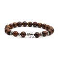 Macro view of tiger eye bead bracelet with detailed silver elephant charm and spacers - Elephant