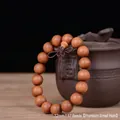 Close-up of 12mm dark brown sandalwood beads with natural wood grain and fine small holes - Exquisite Small Hole / 12mm*17 Beads