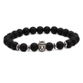 Close-up of matte black agate beads bracelet with a detailed silver lion head charm - Crown Animal