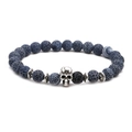 Detail of blue weathered stone beads with a silver skull charm and spacers - Skull
