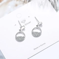 Silver round hoop earrings with cubic zirconia inlay on a professional display card - White Gold Plated Copper
