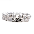 Double-layered white turquoise beaded bracelet featuring a silver leopard head charm - Leopard Head Set