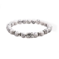 Detailed view of white turquoise beads and metallic Buddha head charm on the bracelet - Buddha Head