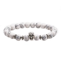 Detailed macro view of white howlite stone beads with silver skull charm on elastic bracelet - Skull