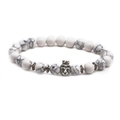 Detailed view of white turquoise marble beads bracelet featuring a silver lion head charm - Crown Animal