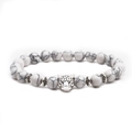 Detail view of white turquoise beaded bracelet featuring a silver leopard head charm - Leopard Head