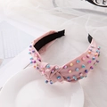 Knot headband with pink fabric and colorful imitation pearls on white plate - Pink