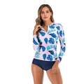 Detail of long sleeve bikini top featuring tropical leaf print and front half-zipper design - S / Blue With Leaves