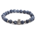 Detail of beaded bracelet with blue ice-crack beads and silver lion head charm - Crown Animal
