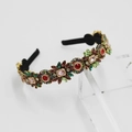 Dettaglio ravvicinato di fiori di cristallo e gemme colorate su fascia di lusso - Zircone Verde
