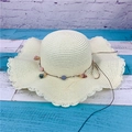Creamy straw sun hat featuring scalloped wavy brim and colorful floral decoration - Adult M / Creamy White