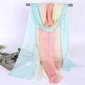 Lightweight gradient chiffon scarf in blue yellow and pink tones hanging on a rack - Macaron Gradient