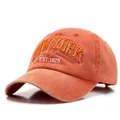 Orange washed denim baseball cap with New York embroidery and vintage distressed finish - Orange