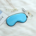 Sky blue satin sleep mask with black elastic strap on white plush fabric background - Adjustable Buckle Paper Card Packaging / Sky Blue