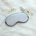 Adjustable light blue silk sleep mask with black elastic strap on white plush background - Adjustable Buckle Paper Card Packaging / Silver