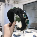 Baroque black knotted headband with large emerald-cut green crystal and rhinestone - Black