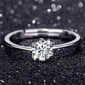 Macro shot of silver classic six-prong zircon ring with adjustable band on bokeh background - Adjustable / Style 7 Classic Six Prong Ring (0.5 Carat)