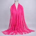 Detail of rose pink hollow lace scarf showing intricate floral patterns and long fringe trim - 180cmx60cm / Rose Red