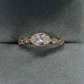 Elegant gold-plated engagement ring featuring an oval zircon center stone in a velvet box - US 5 / 14K Light Gold White Zircon