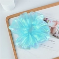 Close-up of shimmering aurora organza scrunchie with iridescent blue light reflections - Mint Green